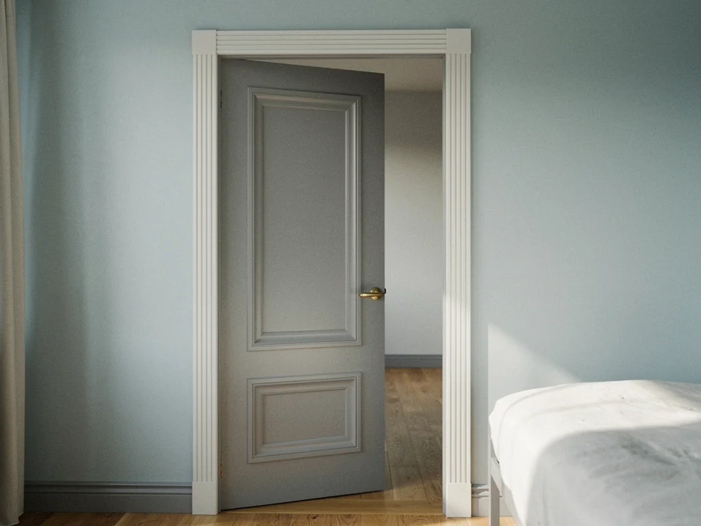 Gray two-panel interior door with a brass lever and white fluted casing.